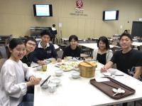 Kunihiro (third from left), Niina (second from right) and Akino (third from right) at a College communal dinner